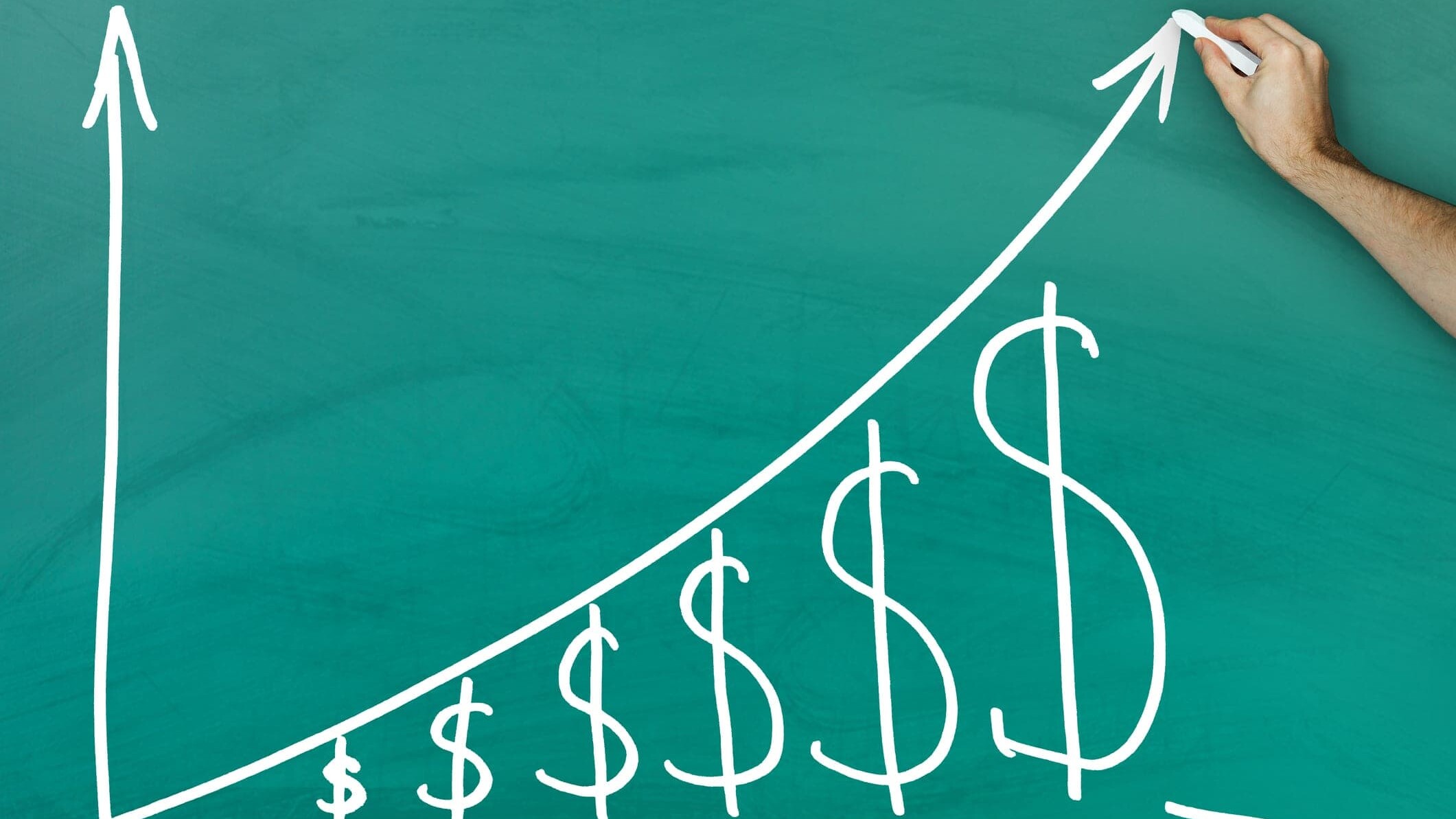 Hand holding chalk dollar growth chart on green blackboard
