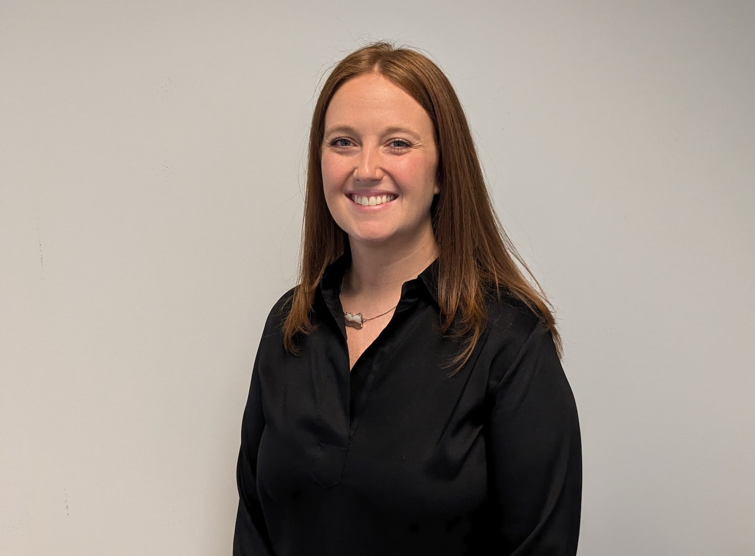 headshot of natalie storey against a background